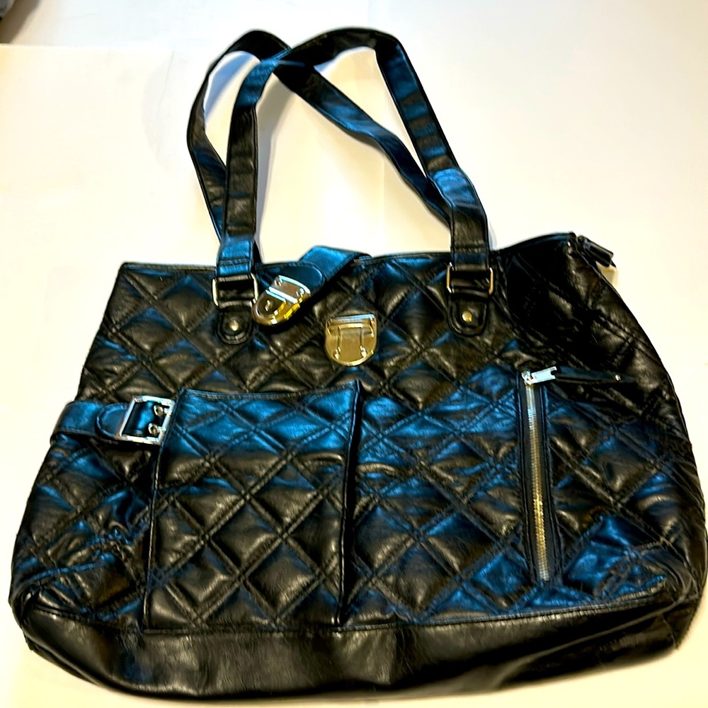 Black tote bag withh 2 outside pockets and 3 inside zipper top closure